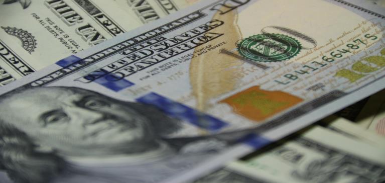 Close up view of a U.S one hundred dollar bill with Ben Franklin.