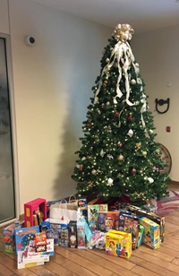 Christmas tree with presents underneath at the Little Chute branch