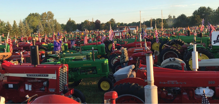 A group of antique tractors ready to cross the Mackinac bridge