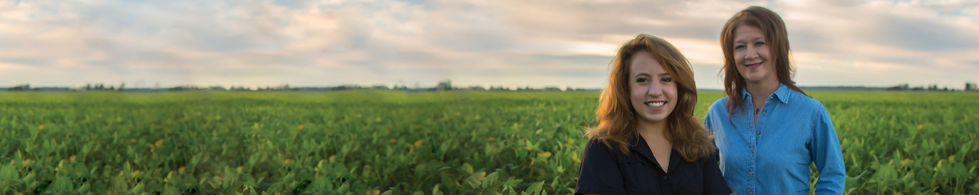 Two women beginning farmers in a crop field
