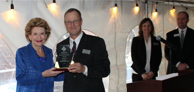 Senator Stabenow accepts award from GreenStone board representative Jed Welder. 