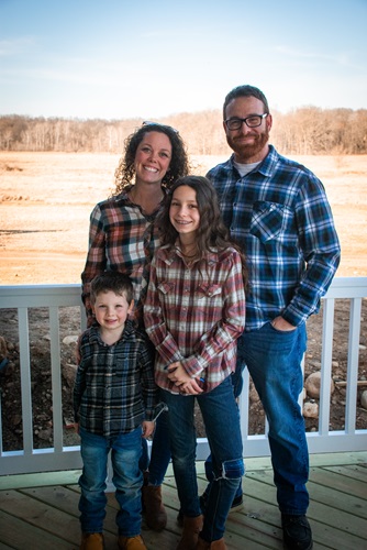 Family of four posing for picture