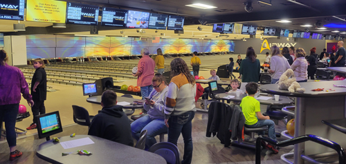 People Bowling in a Bowling Alley