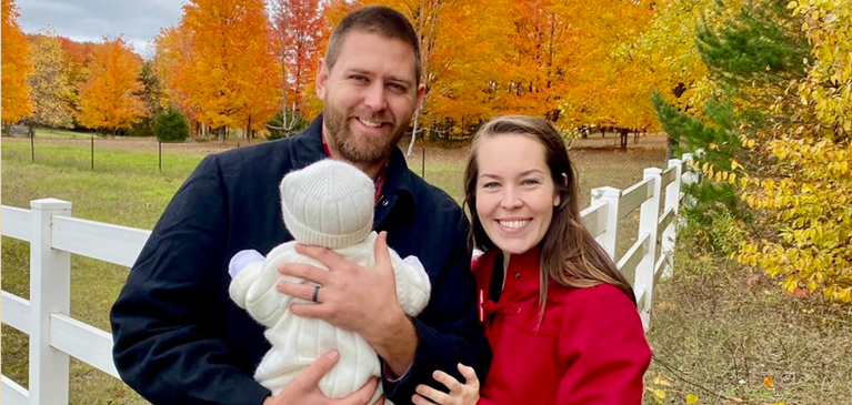 Husband and wife holding baby
