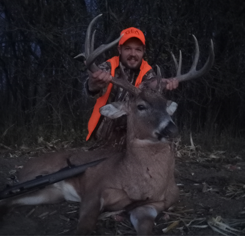 Man holding up a deer