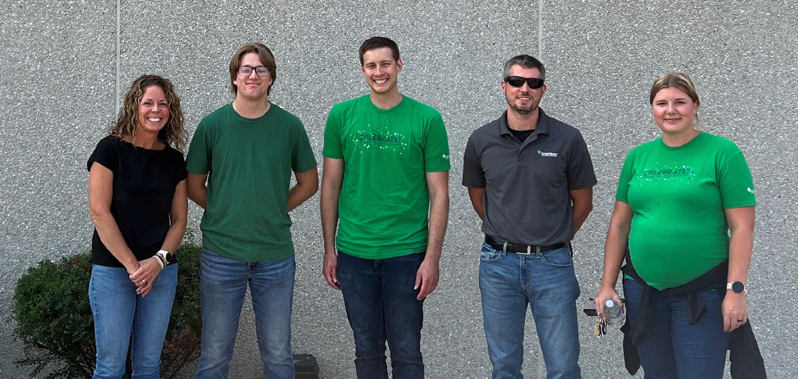 five greenstone employees standing outside of the Feeding America building. 