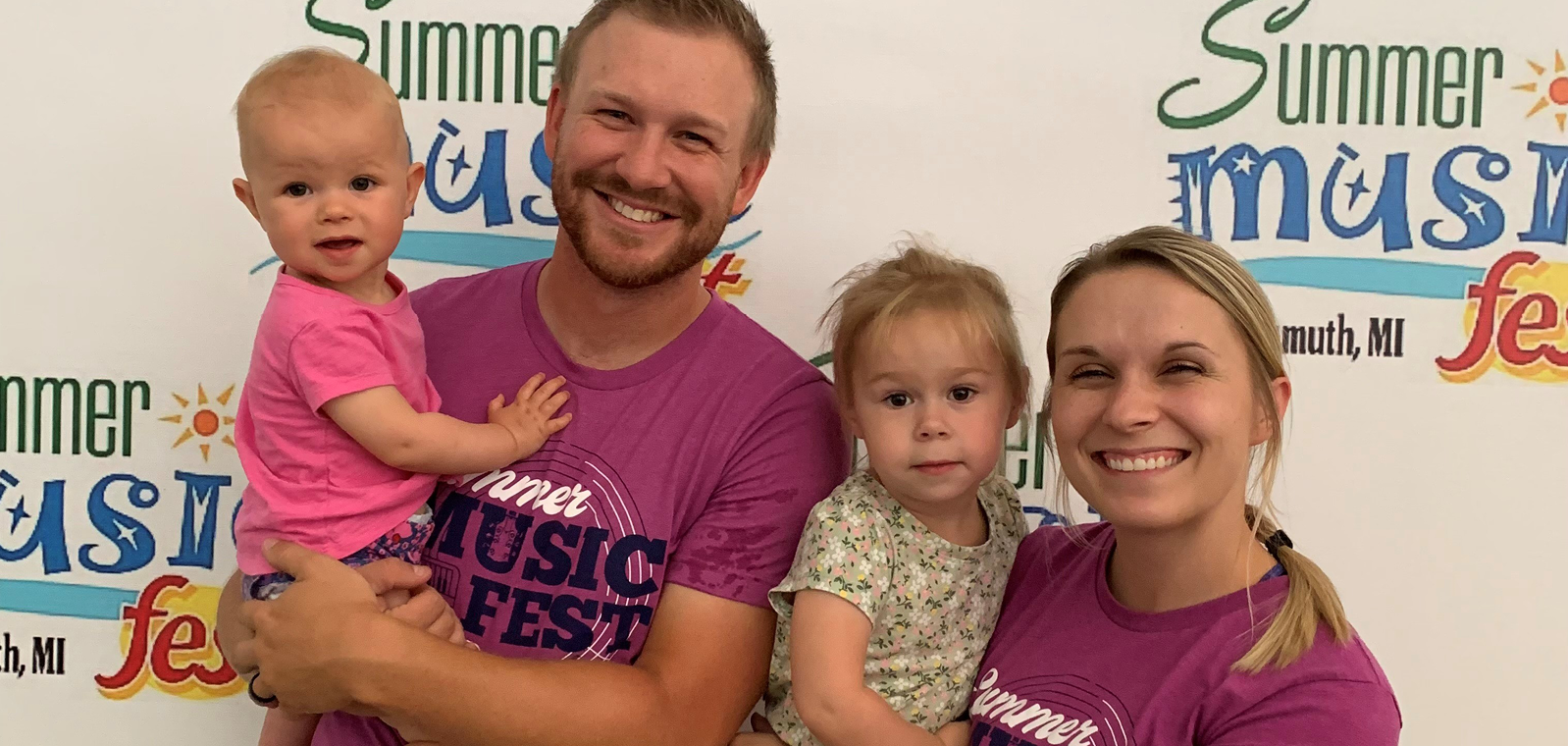Family of four standing for a picture at the festival