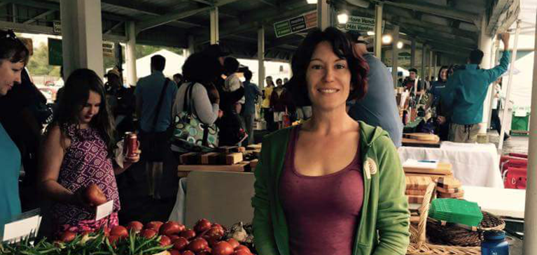 Woman standing in front of a food stand