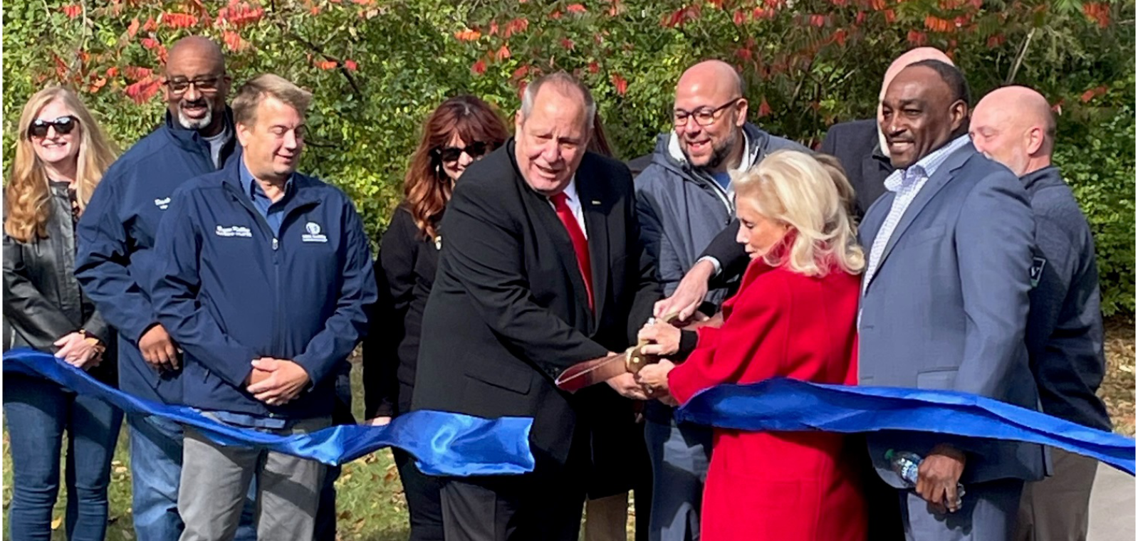 People cutting ribbon, opening the trail