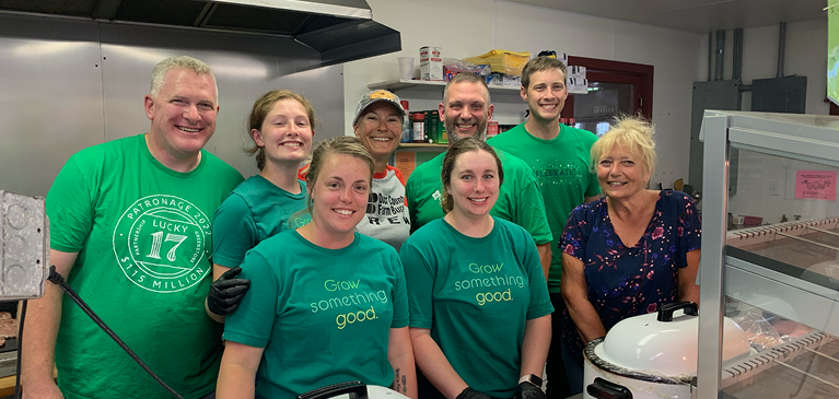 Group of people standing in kitchen