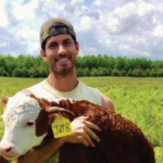 Gregory holding a calf