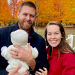 Husband and wife holding baby
