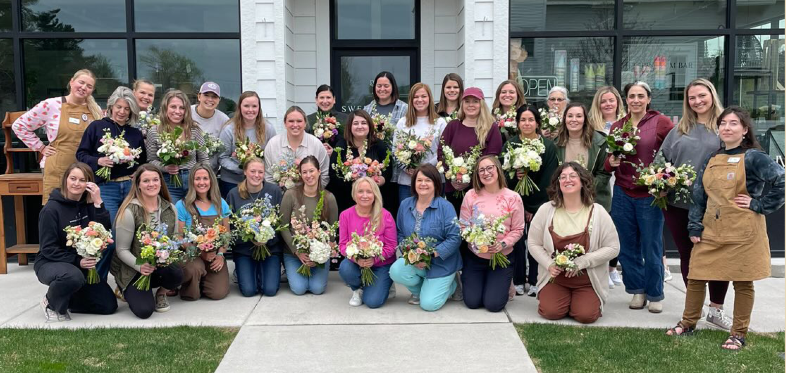 Floral design class holding their bouquets