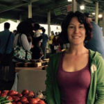 Woman standing in front of a food stand