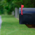Black mailbox along a grassy path