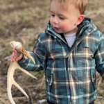 Child holding a deer antler