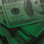 Stack of 100 dollar bills scattered around