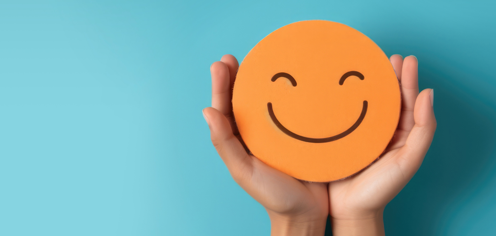 Two hands holding a smiley face