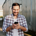 Male farmer checking his phone