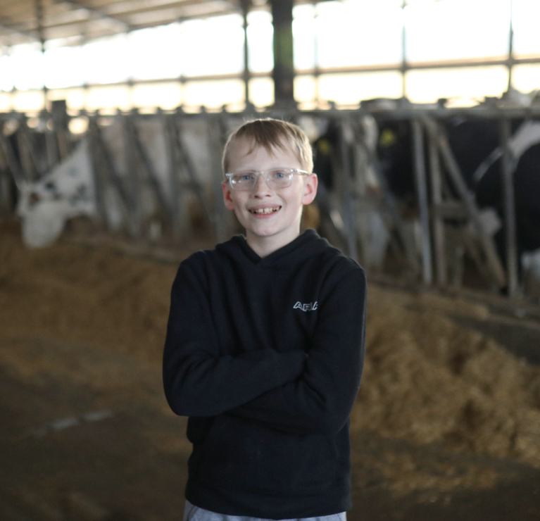 Paul and Renee's grandson enjoys helping out on the farm.