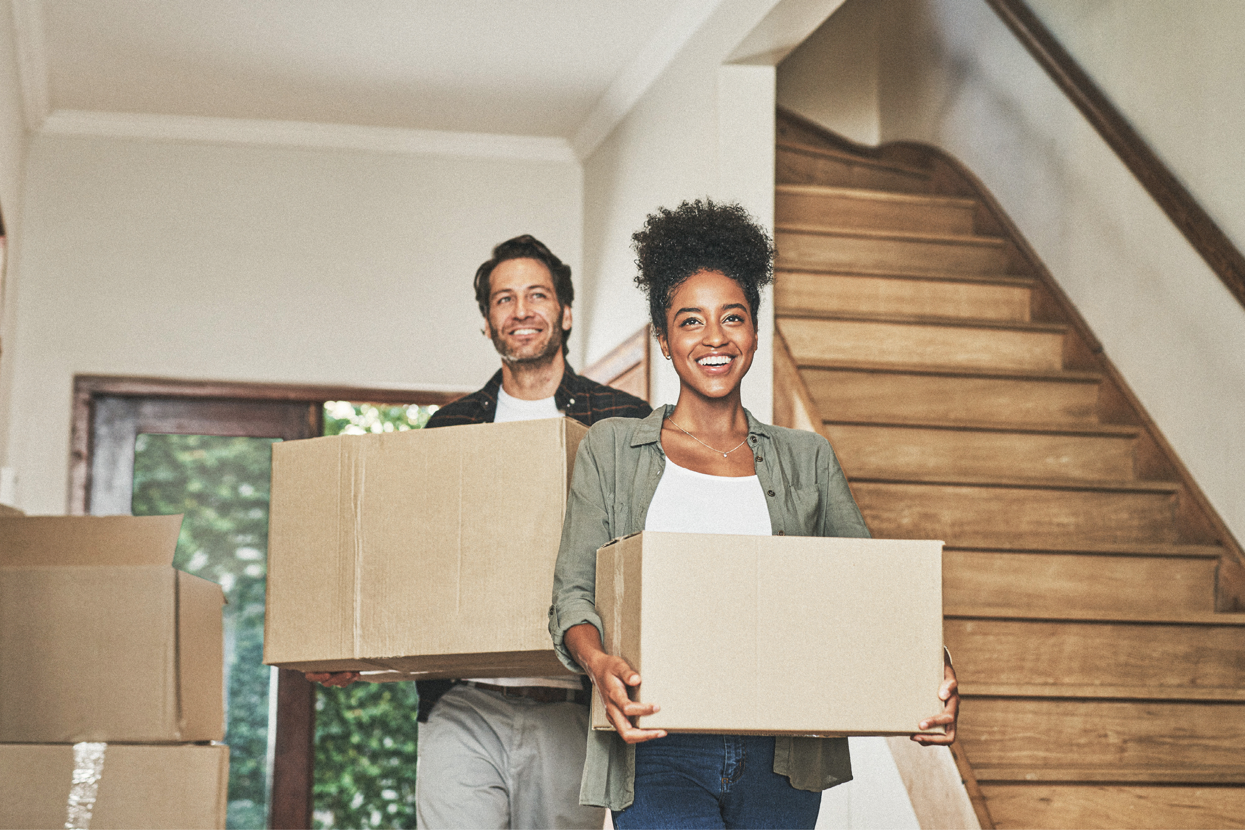 Couple with moving boxes in new home
