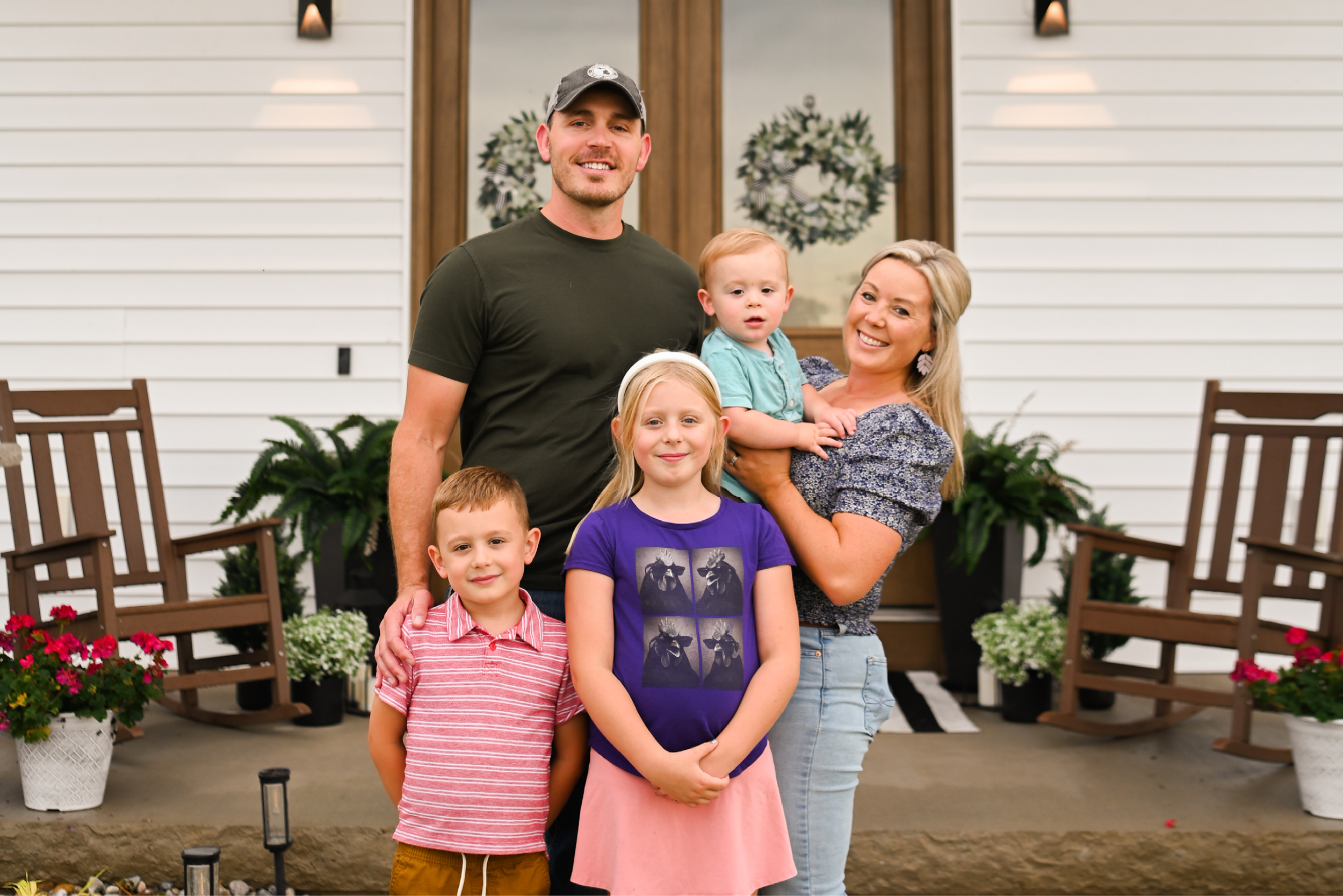 A family standing in front of their home